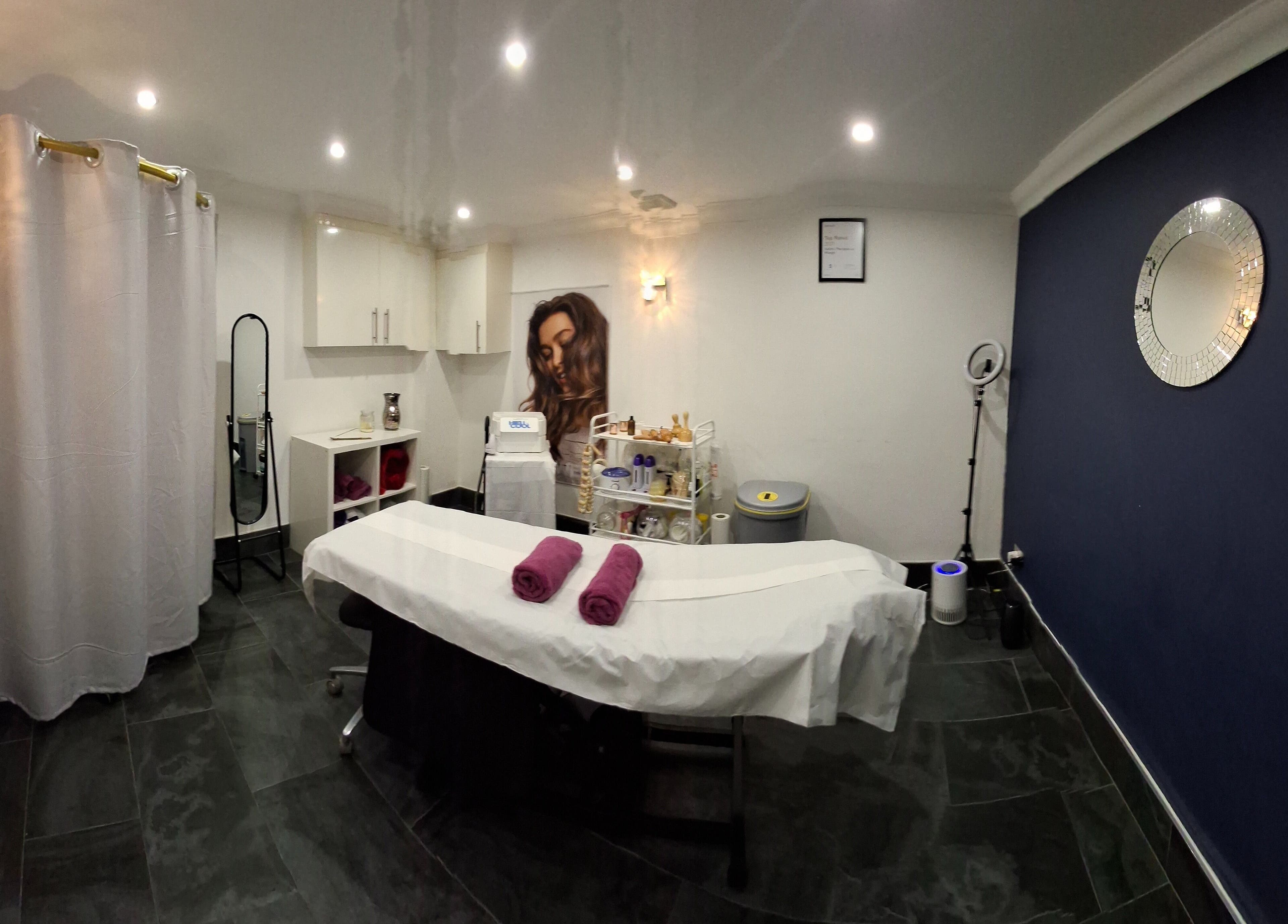 Relaxing treatment room at Facial & Body Contour by Zora, London, England, GB, featuring a massage bed.