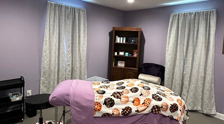 Relaxing spa room at Beautifully Layered Skin, Kernersville, North Carolina, US, featuring a bed with purple decor.