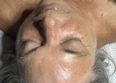 Close-up of a serene face at Beautifully Layered Skin, Kernersville, North Carolina, US, showcasing glowing skin.