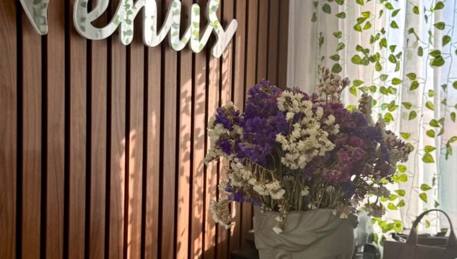 Elegant floral display at Venus Hair Studio, Episkopi, Cyprus, CY against a wooden backdrop.