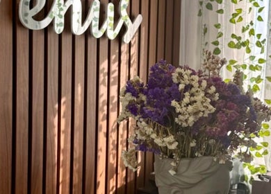 Elegant floral display at Venus Hair Studio, Episkopi, Cyprus, CY against a wooden backdrop.