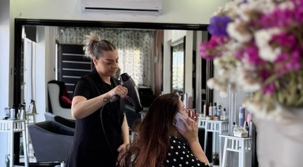 Hairdresser at Venus Hair Studio in Episkopi, Cyprus, CY giving a blowout to a client.