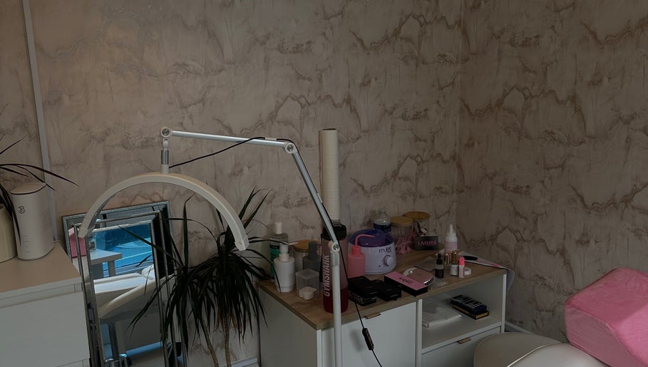 Cozy treatment space at Harriet.Alice.Beauty in Alford, England. Features a lamp, plants, and beauty tools.
