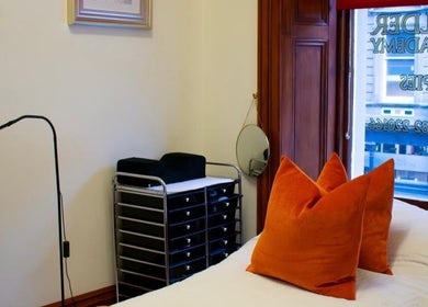 Cozy treatment room with orange pillows at Beauty By Aimee, Dundee, Scotland, GB.