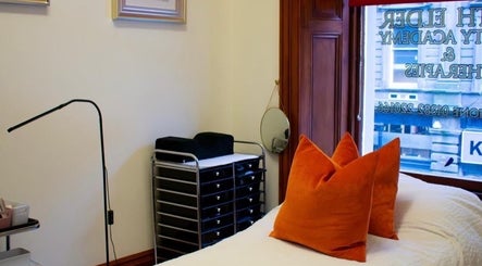 Cozy treatment room with orange pillows at Beauty By Aimee, Dundee, Scotland, GB.