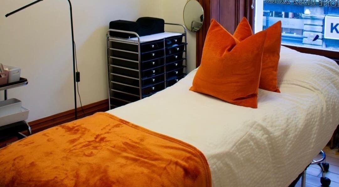 Therapy room at Beauty By Aimee with orange accents in Dundee, Scotland, GB. Cozy treatment space.