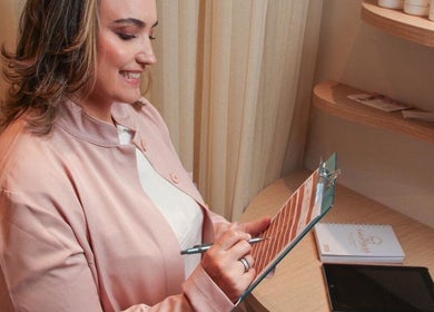 Profissional sorrindo enquanto escreve plano de beleza em Guta Maciel, Minas Gerais, Minas Gerais, BR.