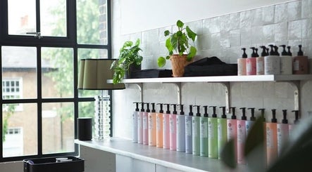 Stylish product display at Hair By Ashley Rose in London, England, GB, featuring lush plants and elegant decor.