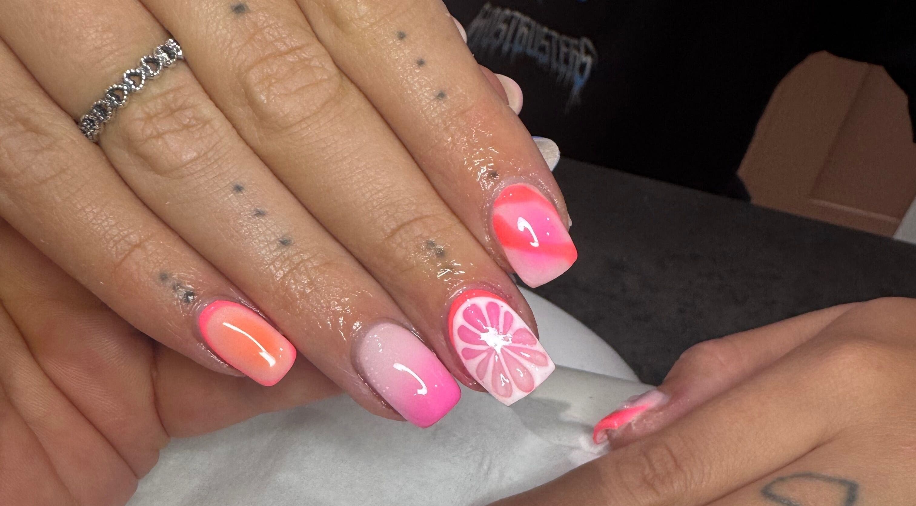 Vibrant citrus-themed nail art at LAnails & beauty, Linlithgow, Scotland, GB, showcasing pink and orange tones.