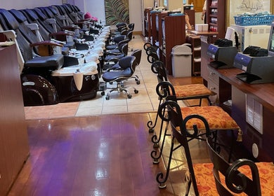 Spacious interior of Nail Place 4U, New York, New York, US with pedicure chairs and workstations.