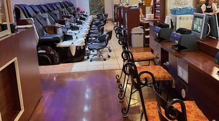 Spacious interior of Nail Place 4U, New York, New York, US with pedicure chairs and workstations.