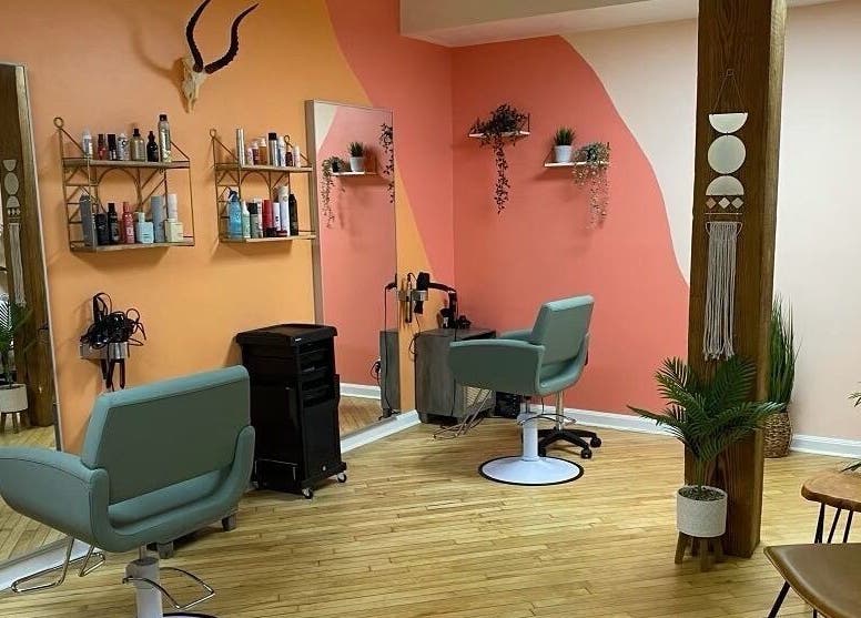 Stylish salon interior at Sarah Helena, Toronto, Ontario, CA, featuring modern chairs and decor.