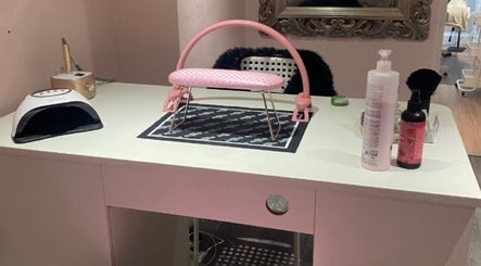 Elegant nail desk at Nail Kouture, Wolverhampton, England, GB, with manicure tools and pink armrest.