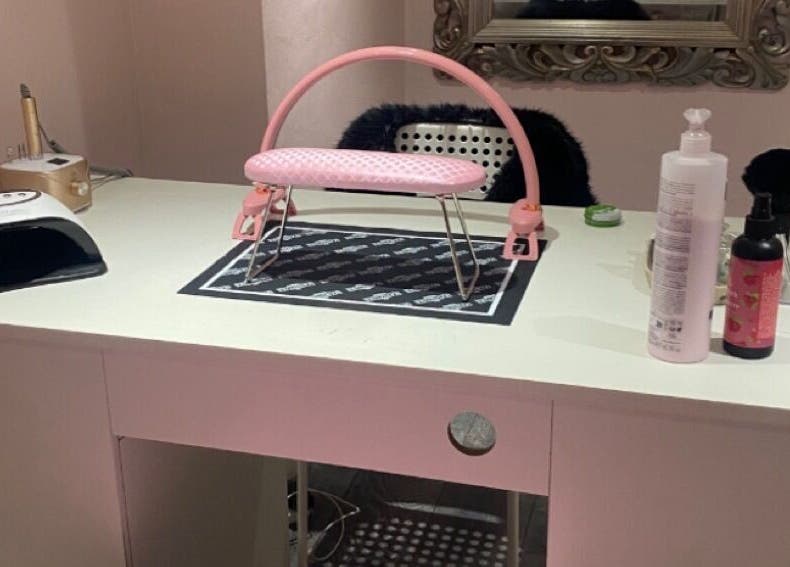 Stylish nail station at Nail Kouture, Wolverhampton, England, GB, featuring a pink armrest and manicure tools.