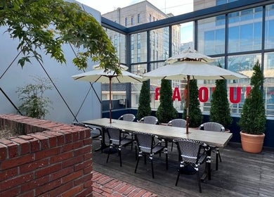 Outdoor seating at JUNO Hair Garden Dosan in 서울특별시, ideal for relaxation and socializing.
