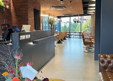 Elegant interior of JUNO Hair Garden Dosan, Seoul, showcasing chic salon setup and lush greenery.