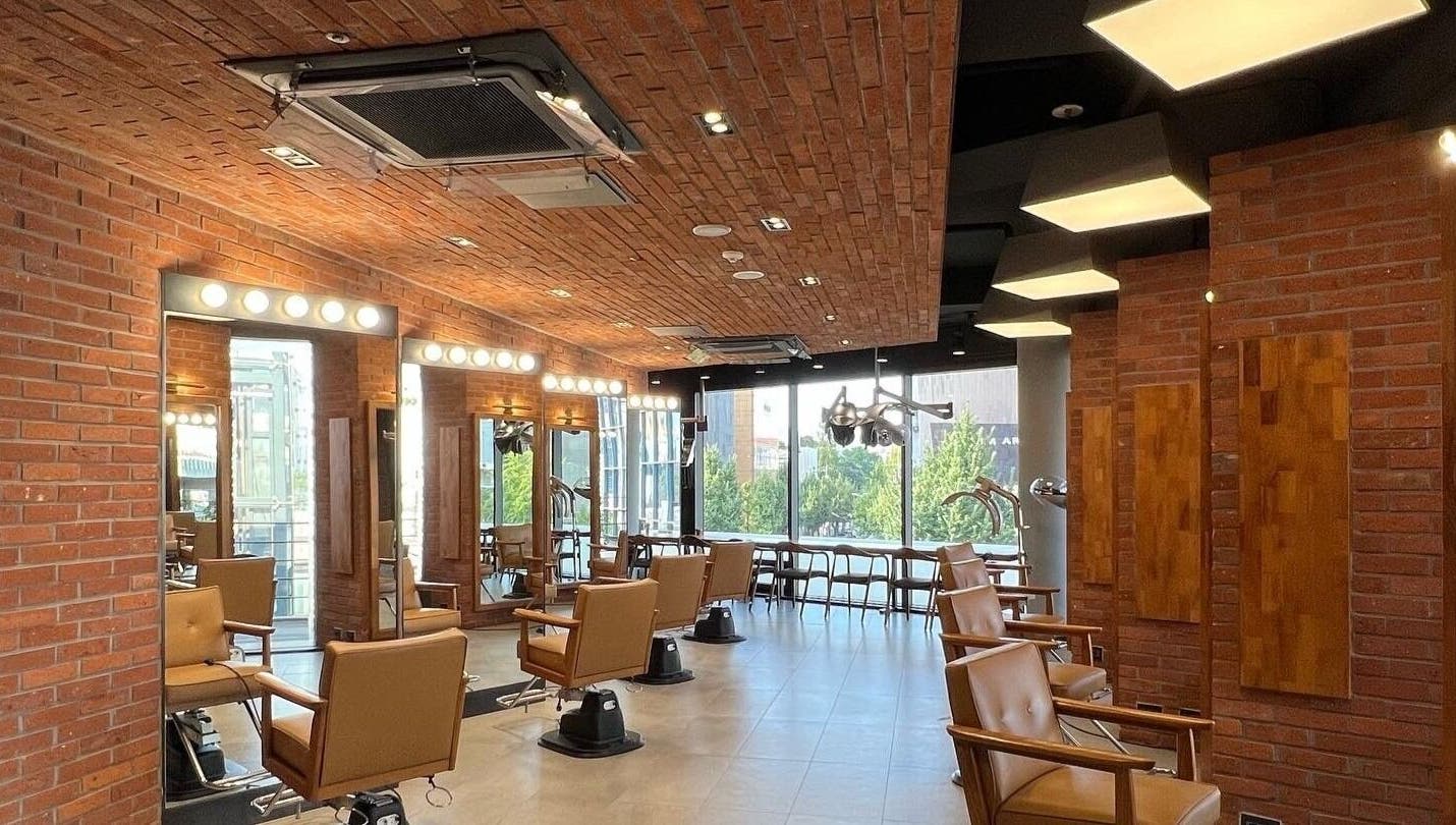 Inside JUNO Hair Garden Dosan with stylish chairs and mirrors. Located at 서울특별시, 서울특별시, KR.