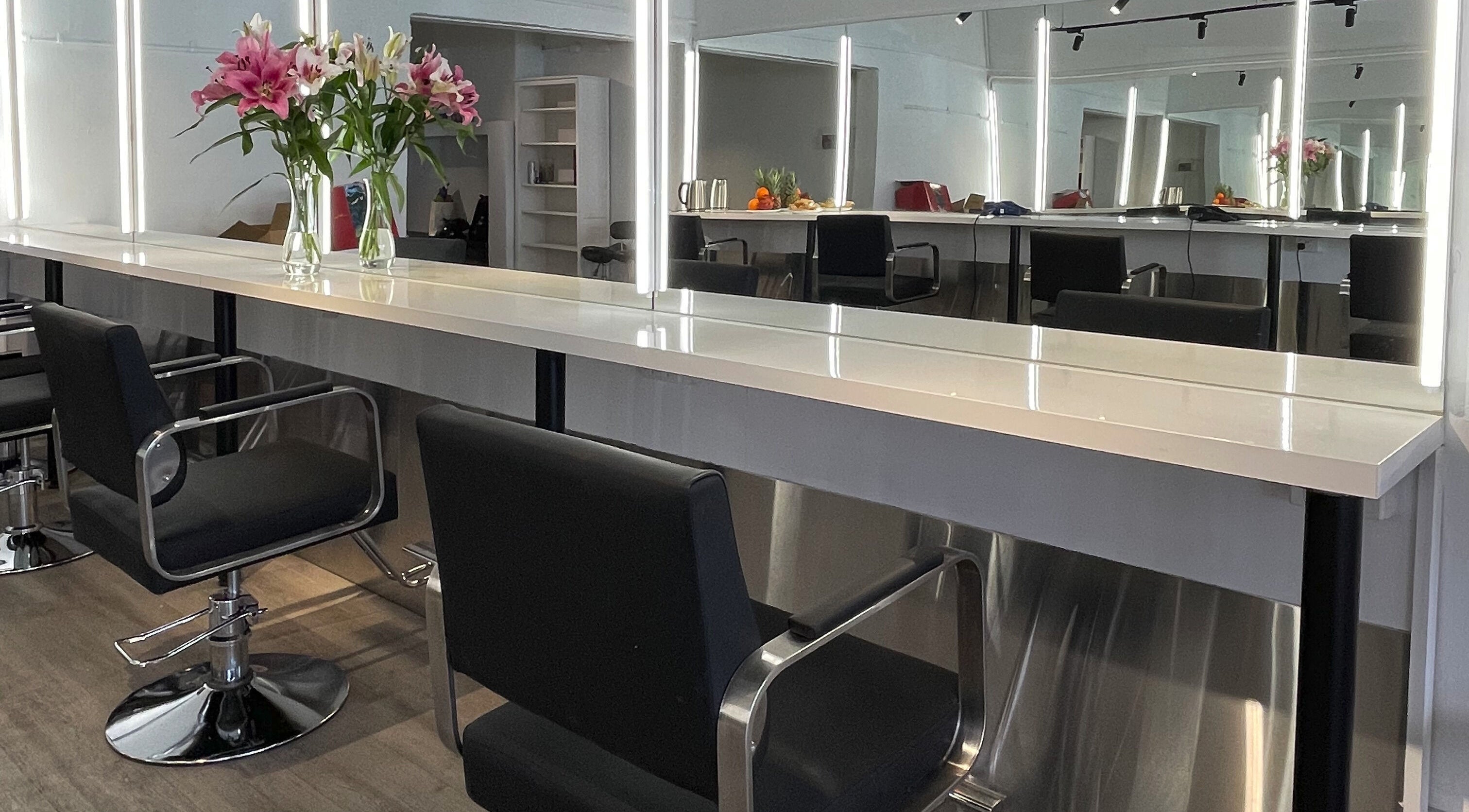 Styled seating and vanity at Ocean Hair Salon Design in Melbourne, Victoria, AU.