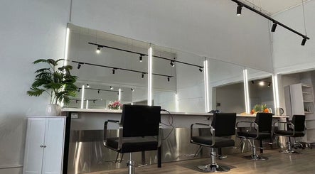 Modern salon design at Ocean hair salon in Melbourne, Victoria, AU with sleek chairs and mirrors.