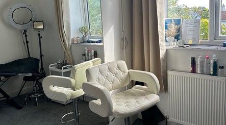 Bright beauty studio at Perfect Brows, Ilford, England, GB with stylish white chairs and beauty tools.