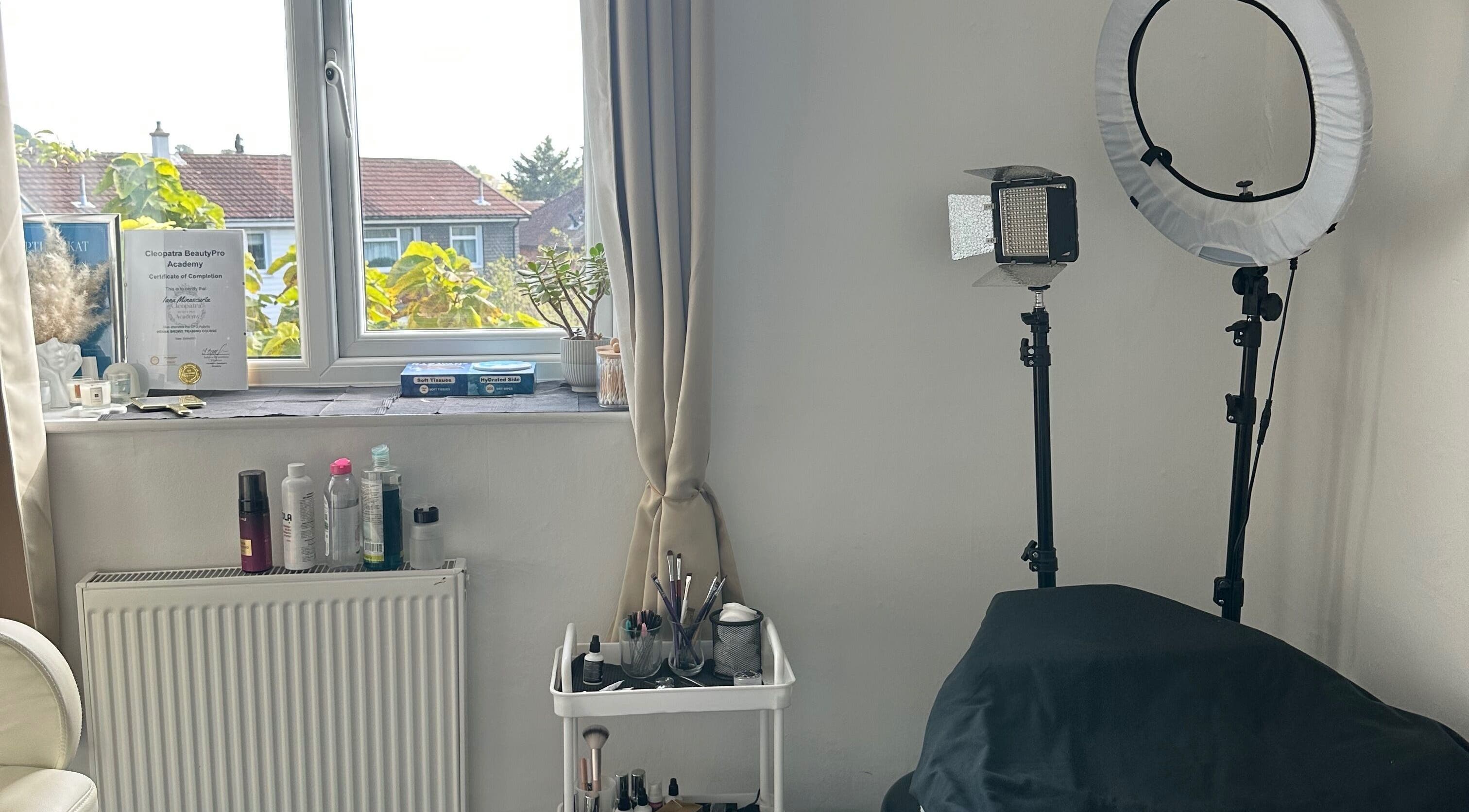 Cozy beauty room setup at Perfect Brows in Ilford, England, GB, featuring makeup and lighting tools.