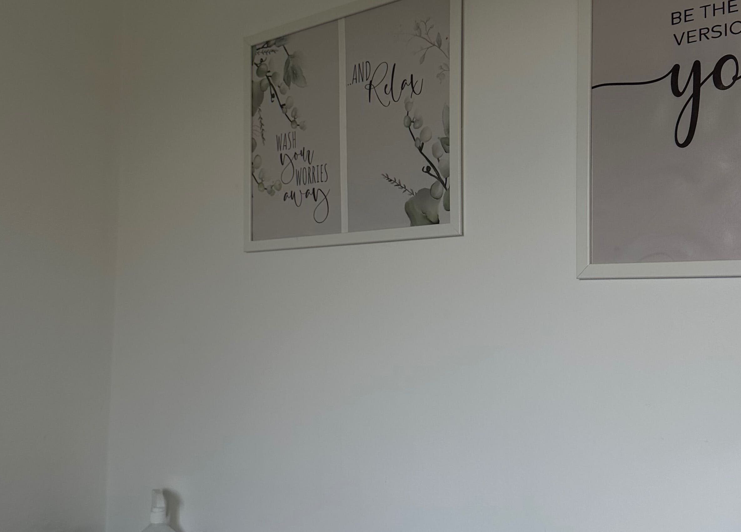 Calming decor at Perfect Brows, Ilford, England, GB with motivational wall art.