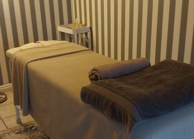 Massage Spa's serene treatment room in Johannesburg, Gauteng, ZA with a cozy massage bed.
