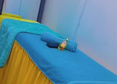 Relaxing massage table setup at Massage Spa, Johannesburg, Gauteng, ZA with vibrant towels and oil.