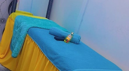 Relaxing massage table setup at Massage Spa, Johannesburg, Gauteng, ZA with vibrant towels and oil.