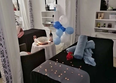 Spa room setup with candles, towels, and balloons at Massage Spa, Johannesburg, Gauteng, ZA.