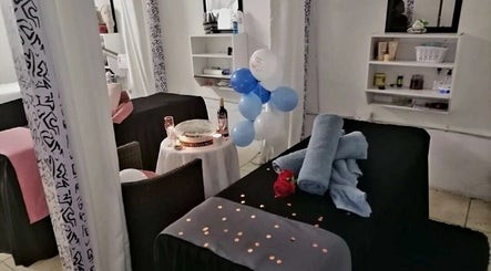 Spa room setup with candles, towels, and balloons at Massage Spa, Johannesburg, Gauteng, ZA.