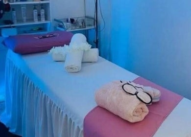 Serene massage room at Massage Spa, Johannesburg, Gauteng, ZA with soft lighting and neatly arranged towels.