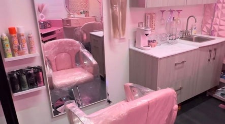 Stylish pink salon interior at BB Boutique, Portland, Oregon, US, featuring chic chairs and beauty products.