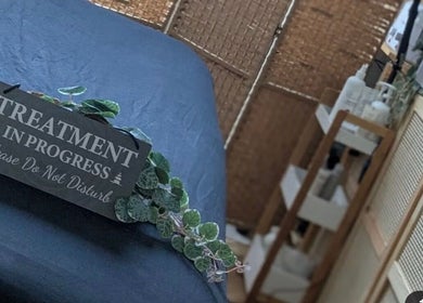 Treatment bed at Samila Gama in London, England, GB with 'Treatment in Progress' sign, ensuring a peaceful atmosphere.