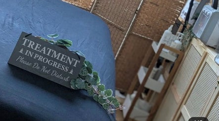 Treatment bed at Samila Gama in London, England, GB with 'Treatment in Progress' sign, ensuring a peaceful atmosphere.