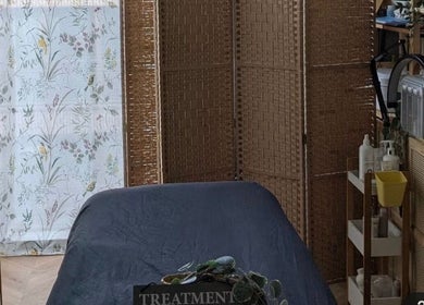 Serene treatment room at Samila Gama, London, England featuring massage table and calming decor.
