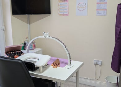 Nail station at Polished by Mrs Hilly in Stockport, England, GB, featuring manicure tools and cozy setup.
