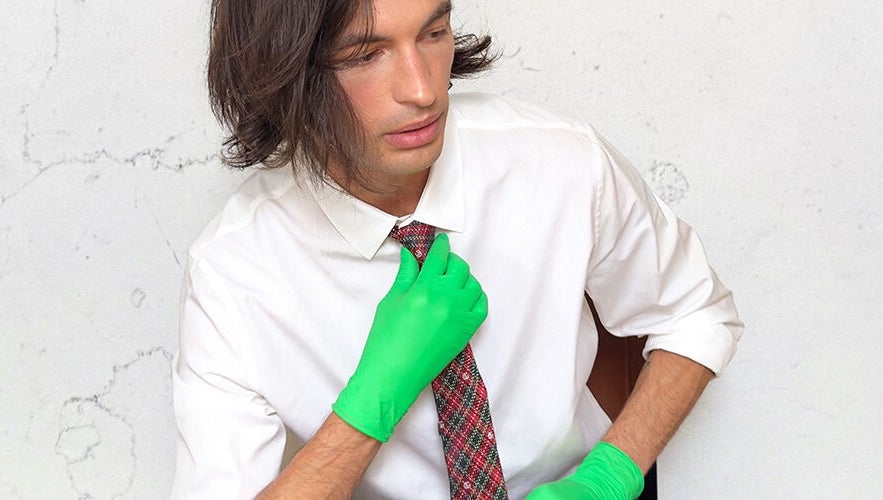 Person in tie and green gloves at FACIAL REBOOT, Milano, Lombardia, IT, showcasing unique style and wellness.