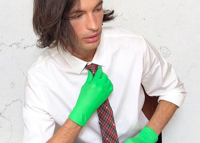 Person in tie and green gloves at FACIAL REBOOT, Milano, Lombardia, IT, showcasing unique style and wellness.