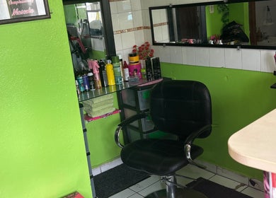 Hair styling chair and products at XQUISITE HAIR, Cole Bay, Sint Maarten, SX with vibrant green walls.