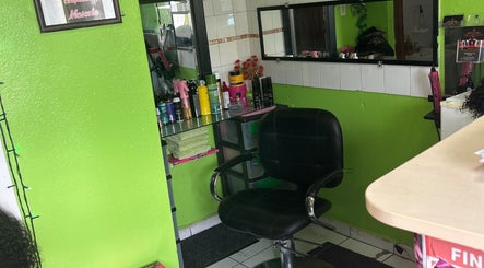 Hair styling chair and products at XQUISITE HAIR, Cole Bay, Sint Maarten, SX with vibrant green walls.