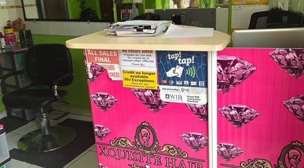 Reception desk at XQUISITE HAIR, Cole Bay, Sint Maarten, SX with salon chair and vibrant decor.