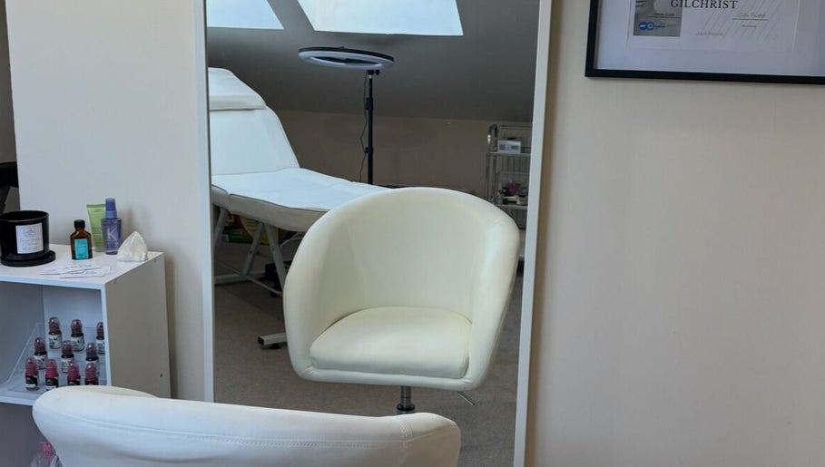Relaxing treatment room at EmpowerHer Beauty in Edinburgh, Scotland, GB, with plush seating and soothing décor.