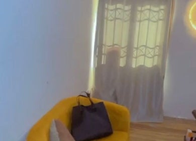 Cozy seating area at EverythingblessingXaesthetic, Lekki, Lagos, NG, with a yellow chair and soft lighting.