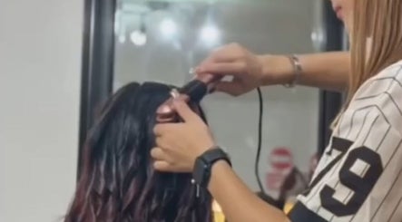 Stylist curling hair at Izzywood.hair, Stoke-on-Trent, England, GB