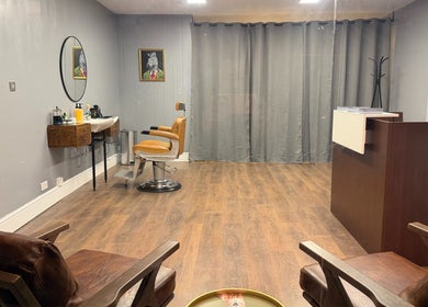 Stylish interior of Sina Grooming Atelier featuring an elegant salon chair in Winchester, England, GB.