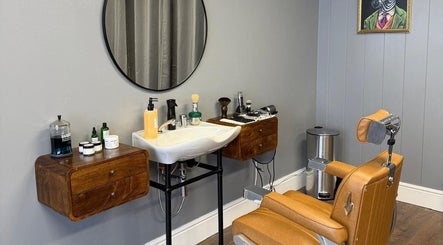 Sleek barber station at Sina Grooming Atelier, Winchester, England, GB, featuring modern chair and grooming tools.