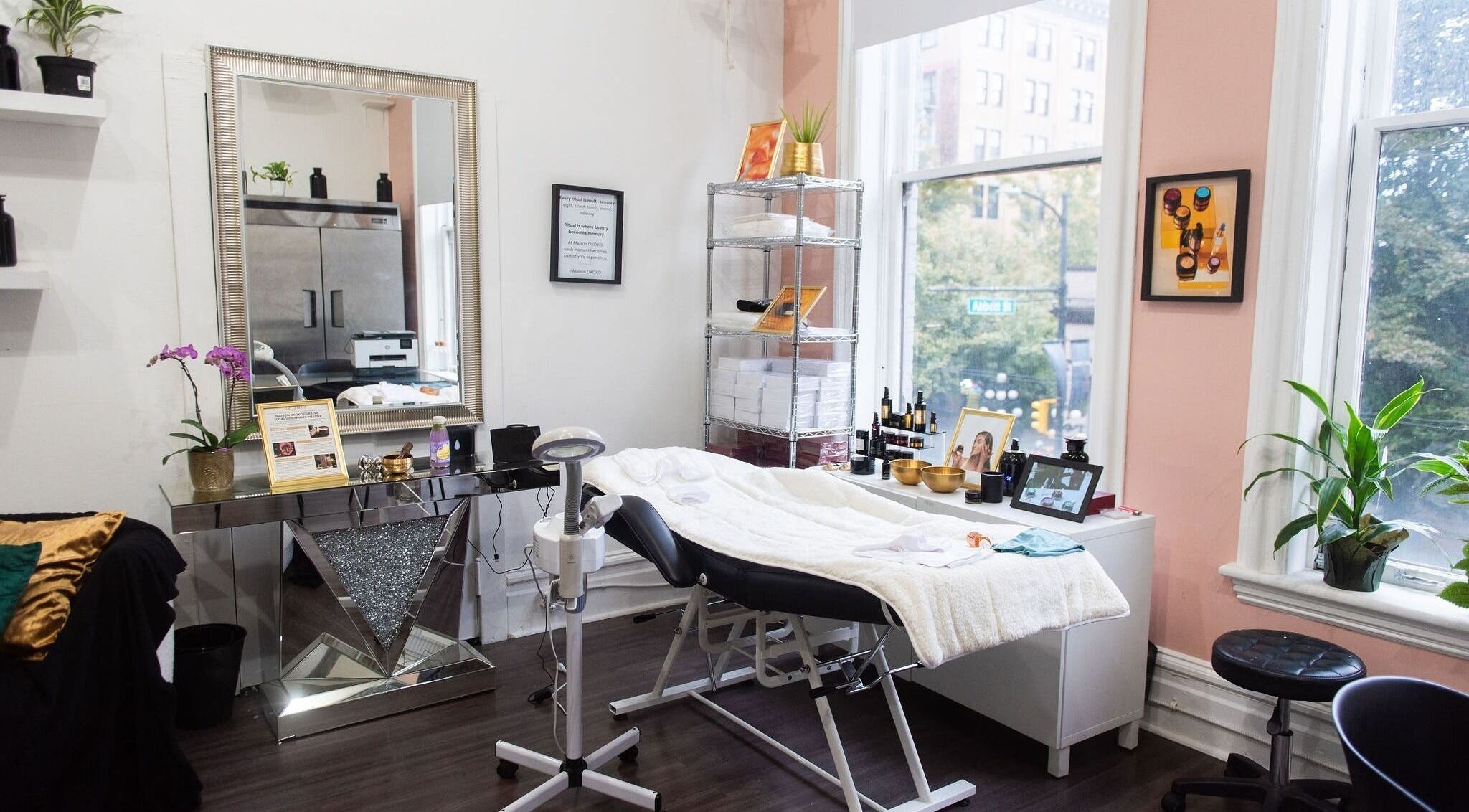Relaxing therapy room at Maison OKOKO, Vancouver, British Columbia, CA, featuring a cozy treatment bed and elegant decor.