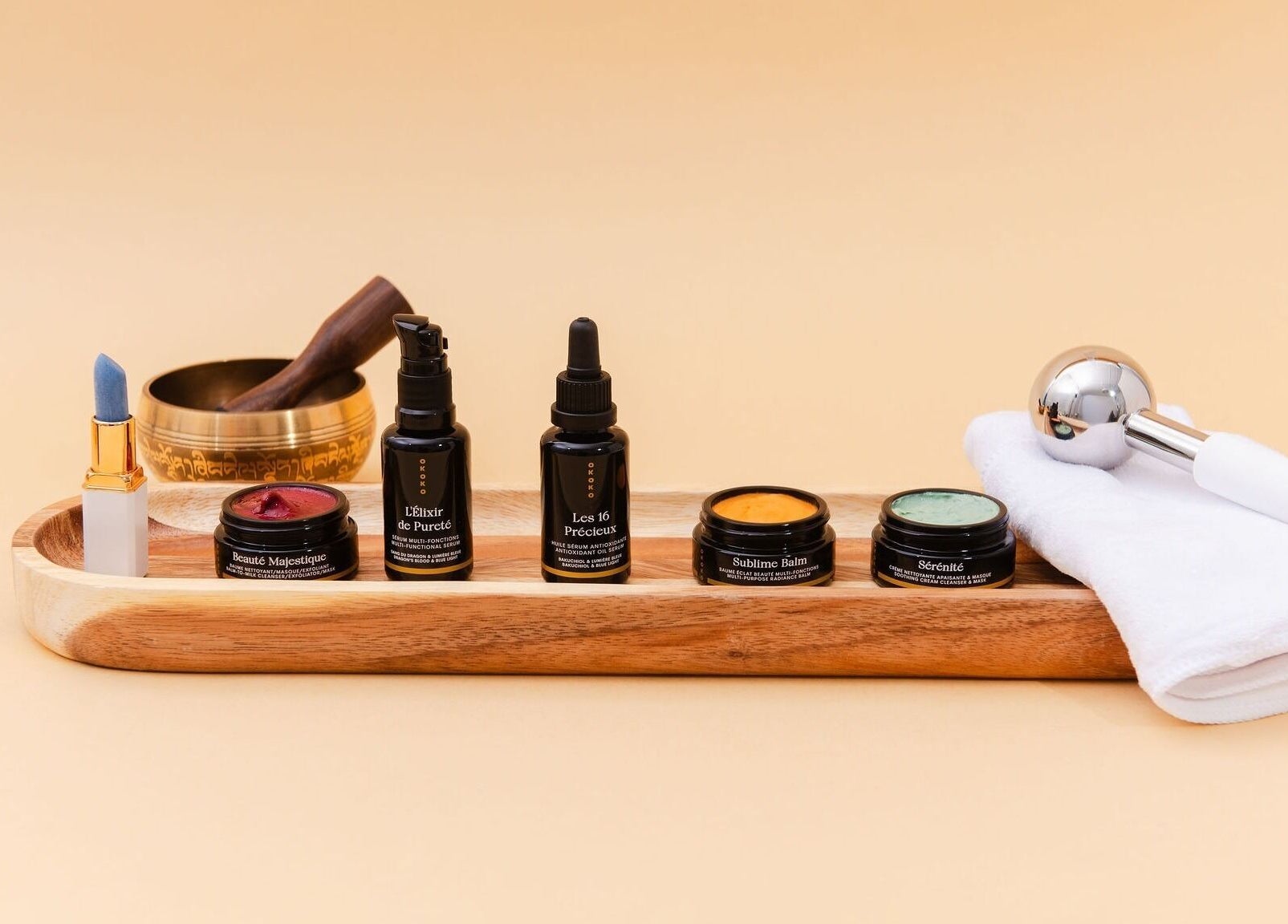 Luxury beauty products at Maison OKOKO, Vancouver, British Columbia, CA, arrayed on a sleek wooden tray.