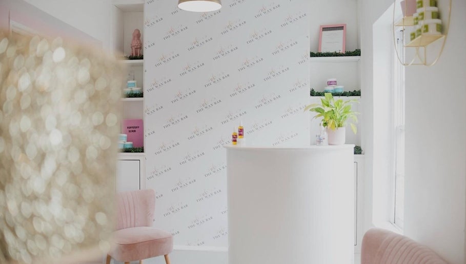 Bright interior of Magi Brows & Lashes in Norwich, England, GB with modern decor and lush plant.